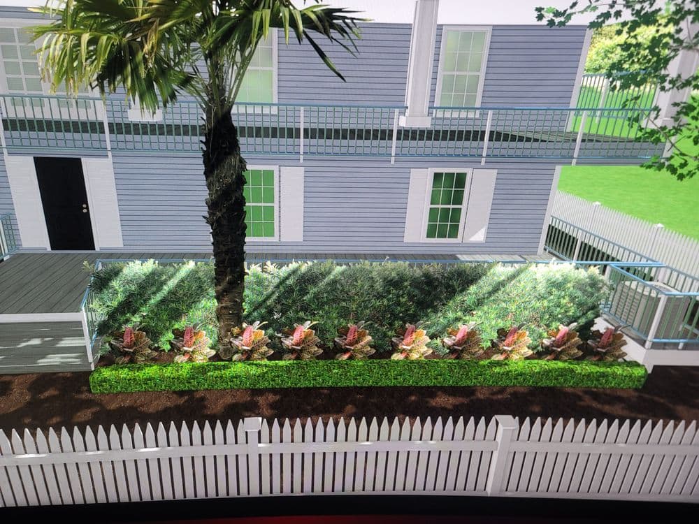 Rendering of a landscaped yard with greenery and colorful plants beside a modern house.